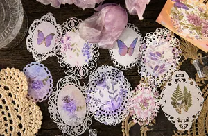 Vue détaillée de stickers en dentelle rétro avec motifs de fleurs violettes et papillons