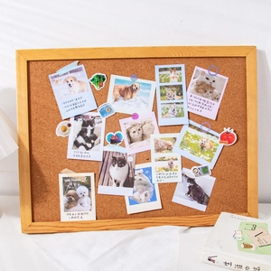 Rectangular cork board with light brown wood frame featuring cute pet photos and stickers