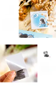 Macro detail of cute animal puppy and bunny stickers being applied to a scrapbook