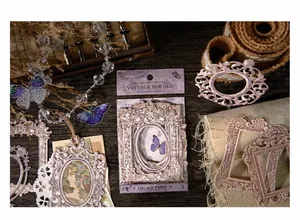 Detailed view of vintage frame stickers with purple ornate designs on dark wood background