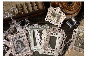 Macro detail of vintage Baroque paper frames on dark wood for journaling scrapbooks