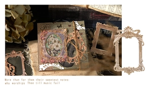 Close-up of vintage European embossed frames with floral and violin patterns on old book