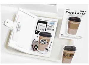 Flat lay of aesthetic coffee themed stickers, a metal binder clip and notebook set