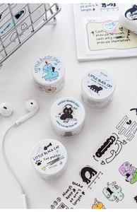Close-up of black cat themed washi tape set on a desk with journals and aesthetic decor