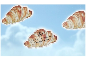 Macro view of croissant shaped sticky notes for scrapbooking with watercolor textures
