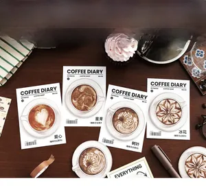 Detailed view of 30 retro coffee latte art memo pads on a vintage wooden desk setting