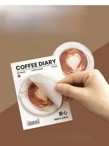 Detail of hand peeling a latte art heart sticky note from the Coffee Diary stationery set