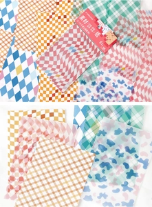 Detail of multi-pattern decorative craft paper including translucent vellum textures