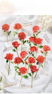 Detail of red long-stem rose stickers with gold foil poetry on white fabric