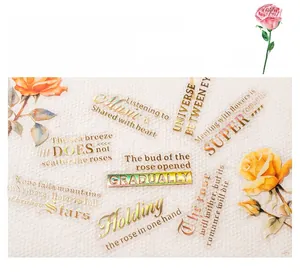 Close-up of rose-themed stickers featuring laser gold foil lettering and floral motifs