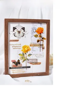 Detail of vintage rose collage sticker with butterfly and wooden frame on white fabric