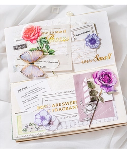 Detail of vintage rose stickers with gold foil accents on a scrapbook layout