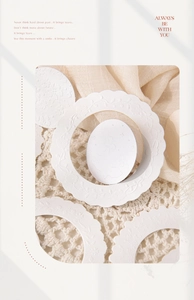 Detail of white embossed floral cardstock with elegant wavy borders for scrapbooking