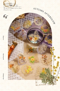 Macro detail of vintage floral PET stickers with gold foil borders and butterflies on wood
