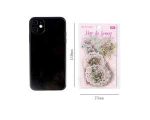 Close-up of vintage floral stickers package next to a phone for size comparison