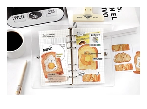 A6 PVC binder set with bread-themed stickers and grid paper on a clean white desk