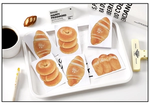 Detailed view of realistic bread-shaped sticky notes and memo pads for journaling