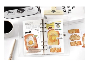 Detail of 6-hole PVC binder with hand-drawn food stickers like toast and orange juice