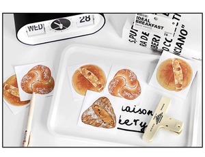 Detail of bread illustration notepad stickers displayed in a creative lifestyle setting