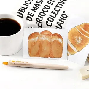 Minimalist bread themed decorative stationery cards for journaling on a white desk setup