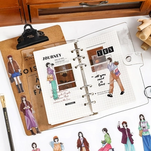 Flat lay of transparent 6-ring binder with fashionable lifestyle character stickers
