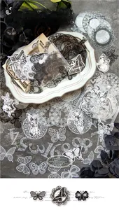 Macro detail of vintage black and white PET stickers with lace and butterfly patterns