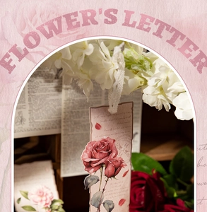 Detail of vintage flower bookmark with red rose, torn edges and white lace ribbon