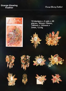 Macro view of vintage gold feather stickers with clock and floral patterns for journals