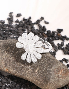 Macro detail of S925 sterling silver daisy ring with micro-paved cubic zirconia stones