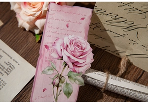 Detail of vintage floral bookmark featuring pink rose and elegant poem on aged paper