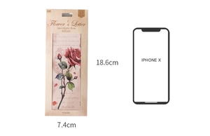 Size comparison of retro flower bookmarks with iPhone X showing 18.6cm by 7.4cm dimensions