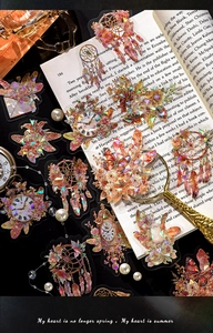 Detailed macro of vintage iridescent laser stickers featuring clock and floral motifs