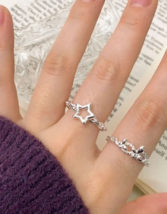 Detail of S925 sterling silver chain ring with star charm and braided knot style