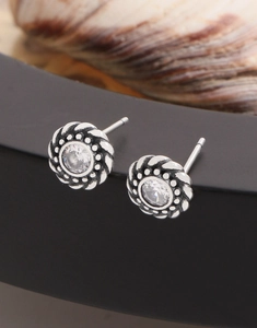 Close-up of vintage S925 silver twist stud earrings with a central clear zircon crystal