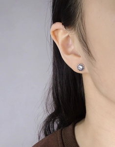 Close-up of S925 silver twist rope stud earring with a central clear zircon on ear