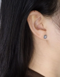 Close-up of vintage S925 sterling silver twist earring with a sparkling center zircon stone