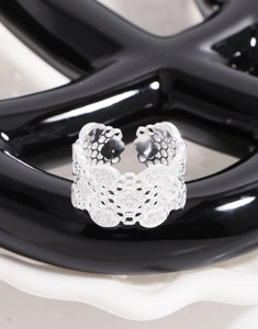 Macro detail of S925 sterling silver wide honeycomb lace ring with sparkling crystals