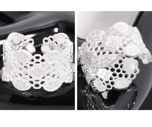 Macro shot of S925 sterling silver wide band ring featuring honeycomb hollow lace patterns