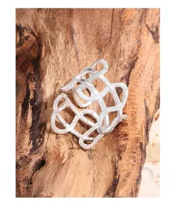 Macro shot of S925 sterling silver irregular woven hollow ring on wooden texture