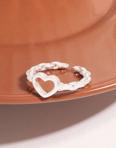 Macro shot of S925 sterling silver chain ring with heart hollow design and open band
