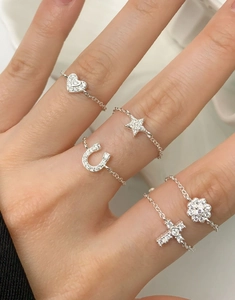 Close-up of S925 sterling silver chain rings with heart star and floral charms
