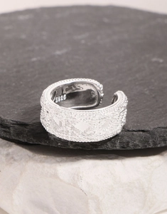 Macro detail of S925 sterling silver ring showing intricate woven texture and s925 stamp
