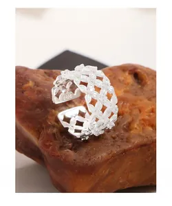 Macro detail of S925 sterling silver mesh lace ring with floral pattern and logo stamp