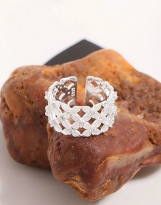 Macro shot of S925 sterling silver mesh lace ring with fine cubic zirconia on a stone