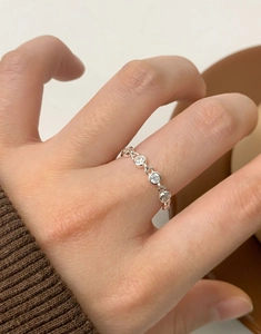 Macro shot of S925 sterling silver bubble ring with zircons worn on model finger