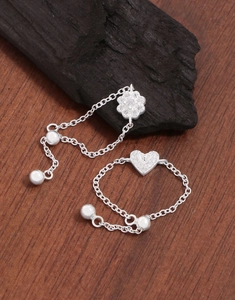 Close-up of S925 sterling silver heart and flower pendants with cubic zirconia