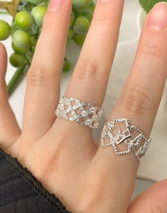 Detail view of S925 sterling silver mesh lace rings with intricate floral and hollow design