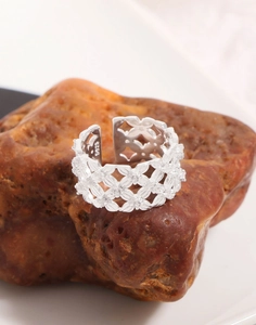 Close-up of S925 sterling silver stamp on intricately woven lace pattern open ring