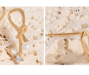 Close-up of S925 sterling silver bow earrings with elegant pearl and zircon details