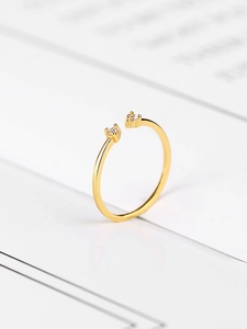 Detail of minimalist gold-plated silver ring with two sparkling zircon stones